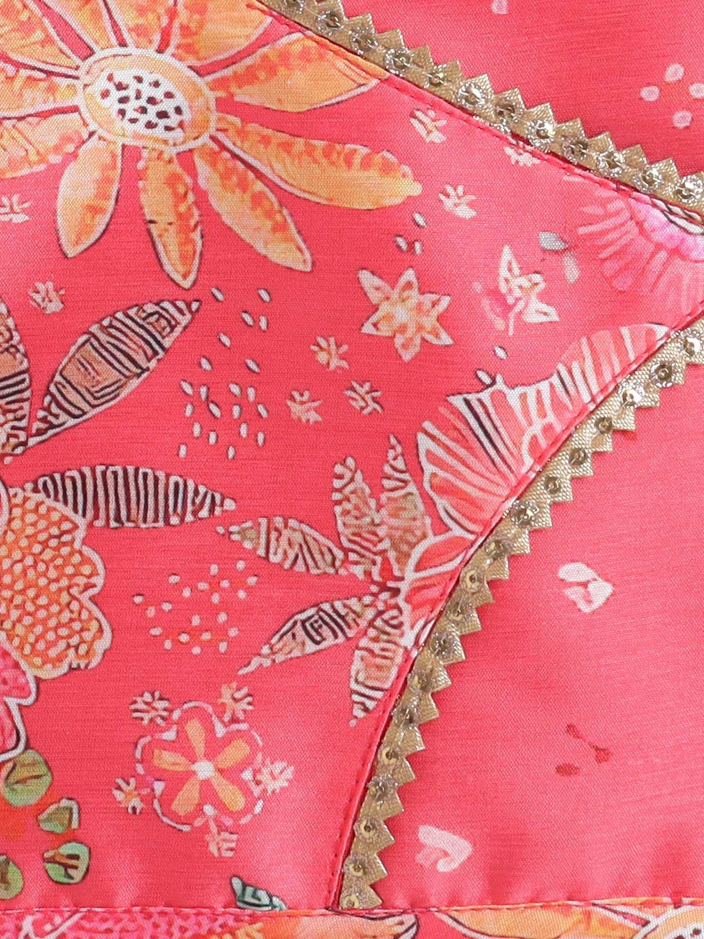 Close-up of a pink fabric with floral patterns and gold trim