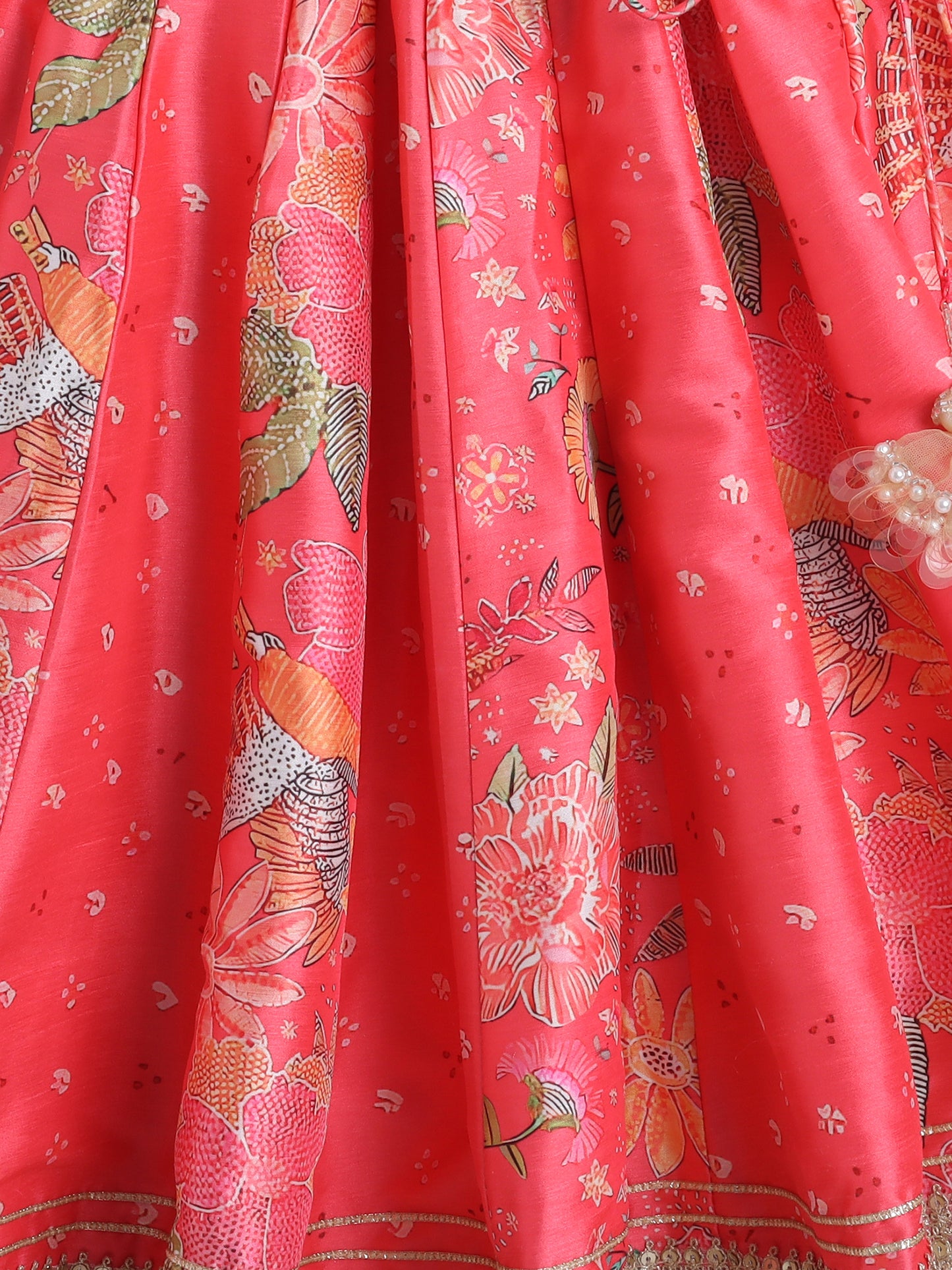 Red fabric with intricate gold and white floral patterns