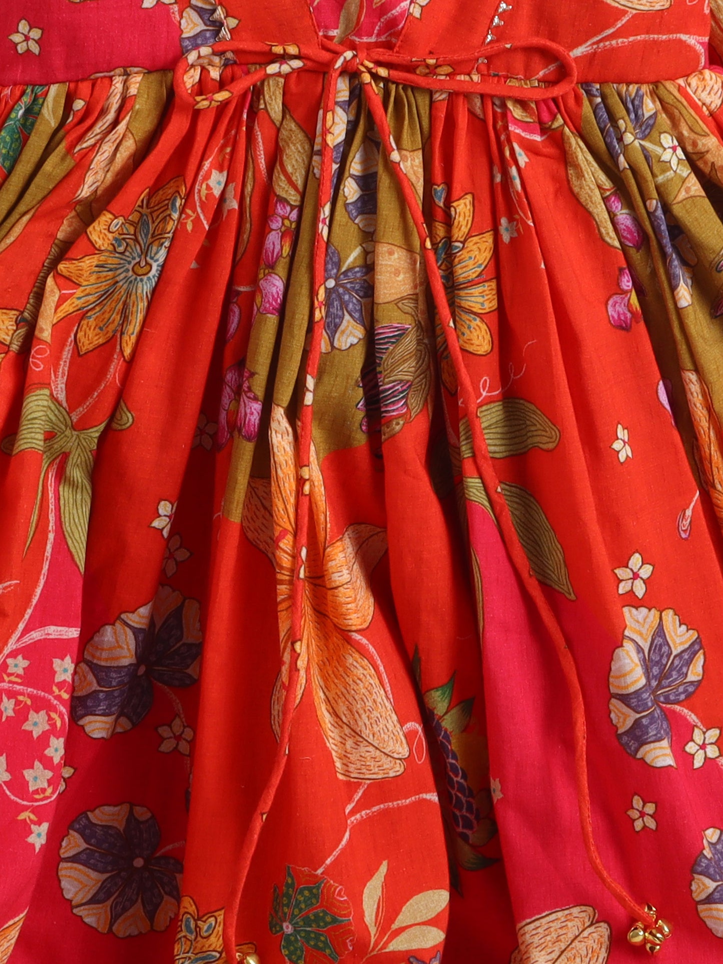 Close-up of a red floral dress with a tie waist.