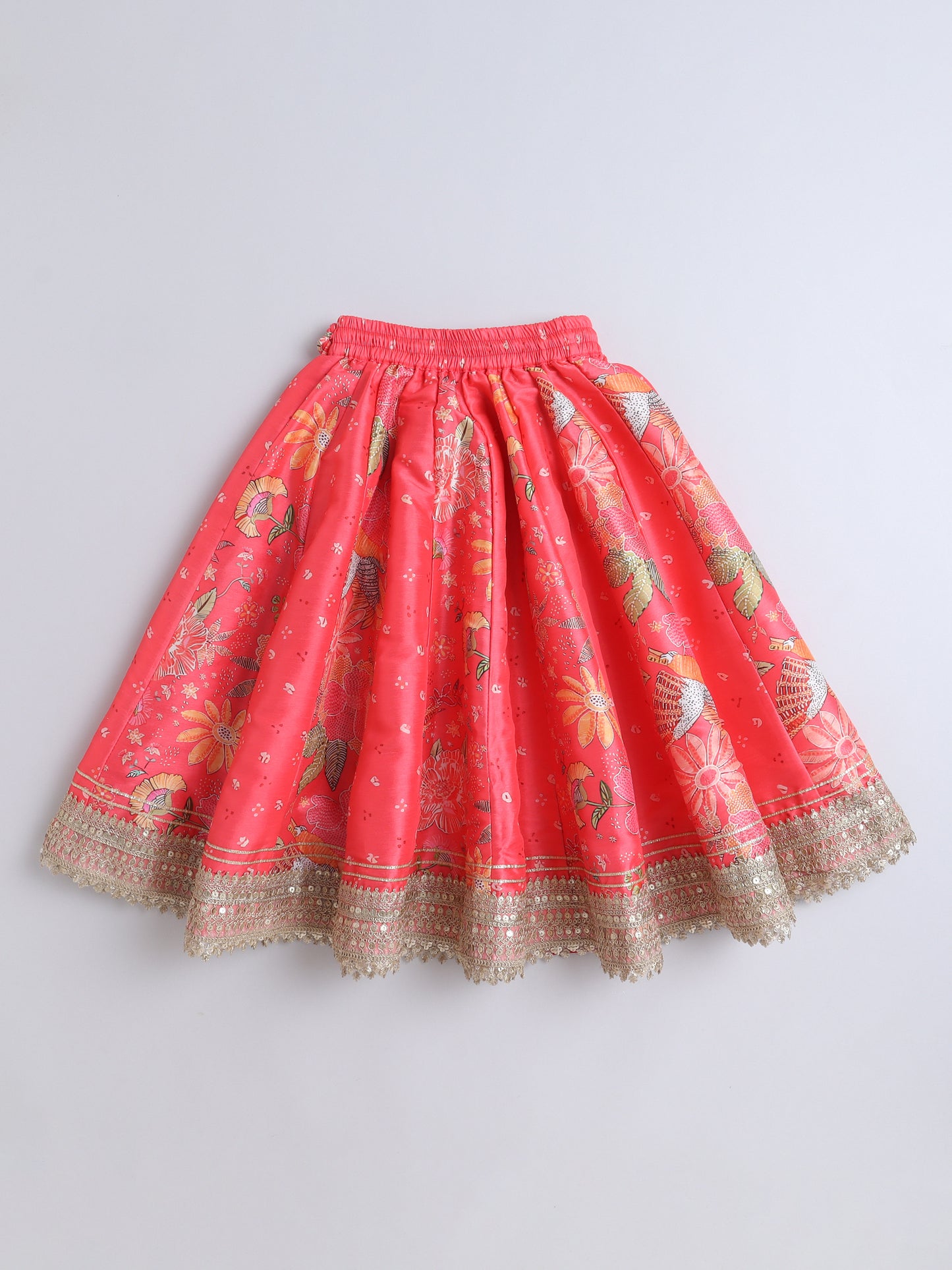 Red skirt with floral patterns and gold trim on a light gray background