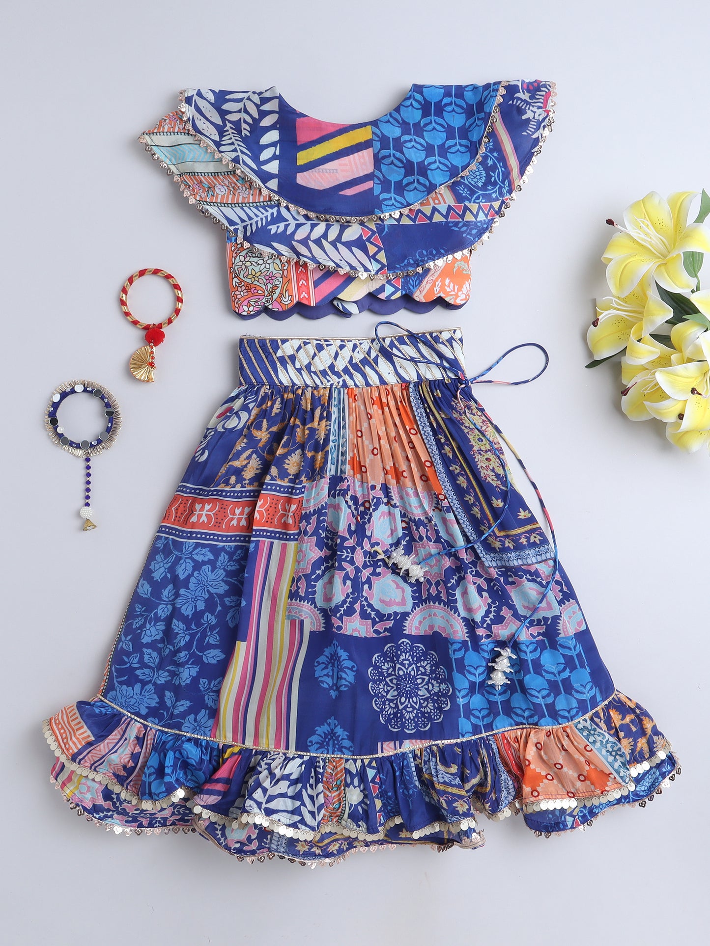 Colorful patterned dress with matching accessories on a blue background