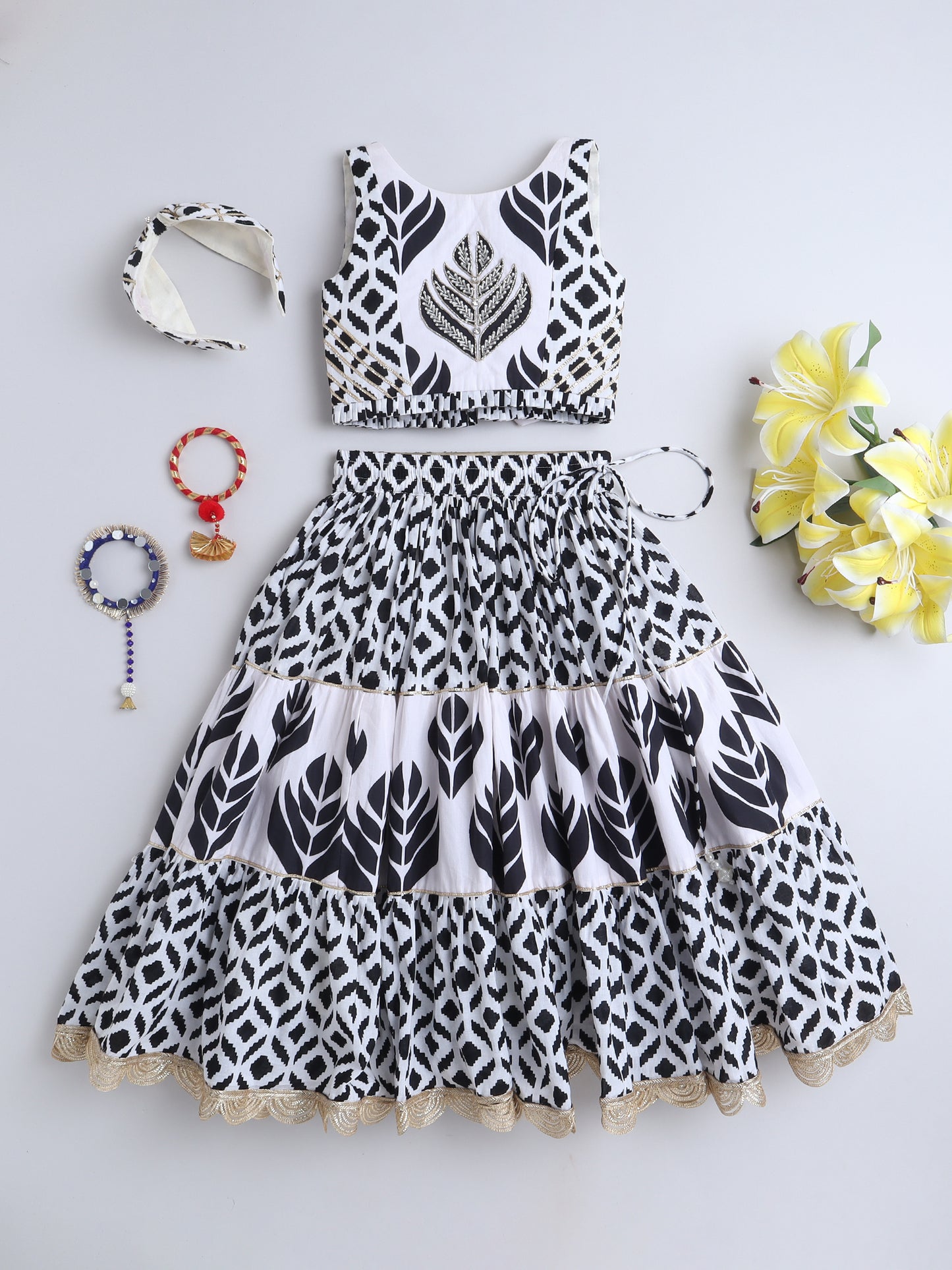 Black and white Lehenga Choli set with floral prints, matching accessories, and a stylish design