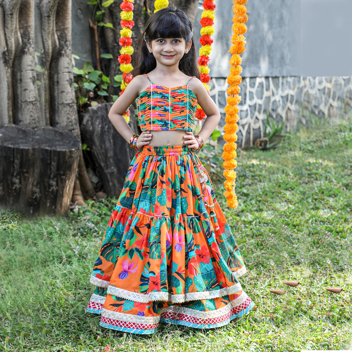 Girls Beautifully Crafted Orange Pleated Spaghetti Strap Top And Printed Layered Lehenga - funlittleones.com