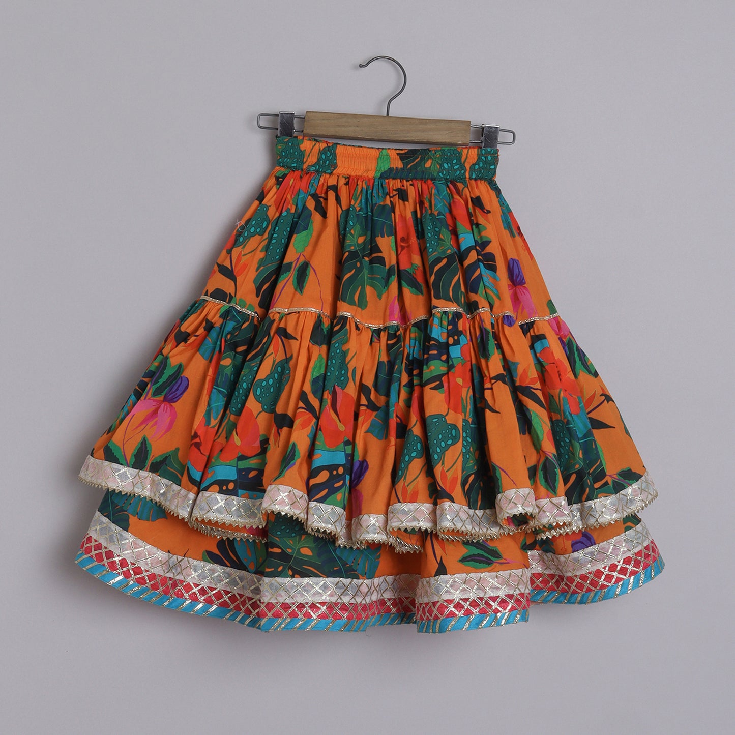 Girls Beautifully Crafted Orange Pleated Spaghetti Strap Top And Printed Layered Lehenga - funlittleones.com