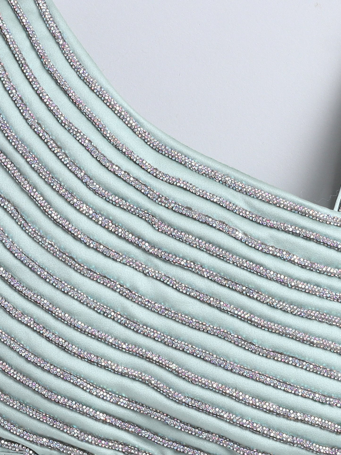 Close-up of a textured fabric with horizontal stripes on a light blue background