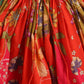 Close-up of a red floral dress with a tie waist.