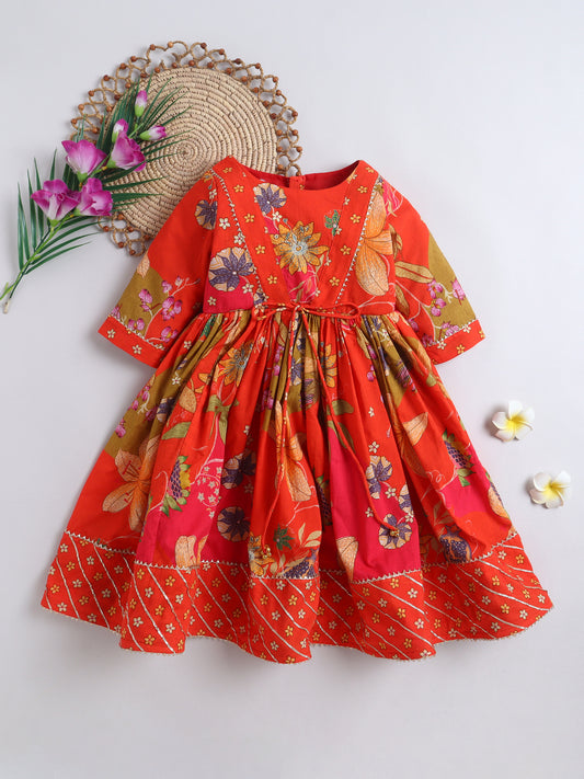 Red floral dress on a white background with decorative elements.