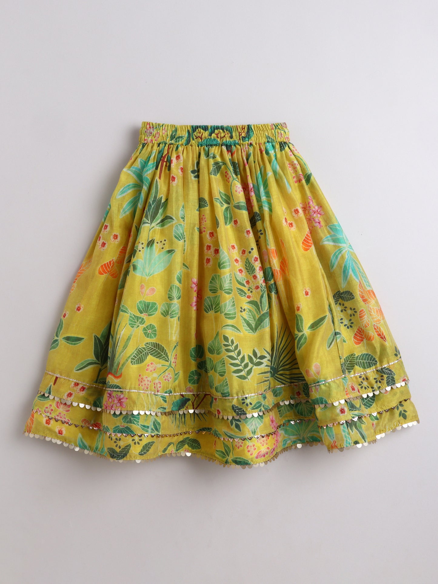 Yellow skirt with floral pattern on a gray background