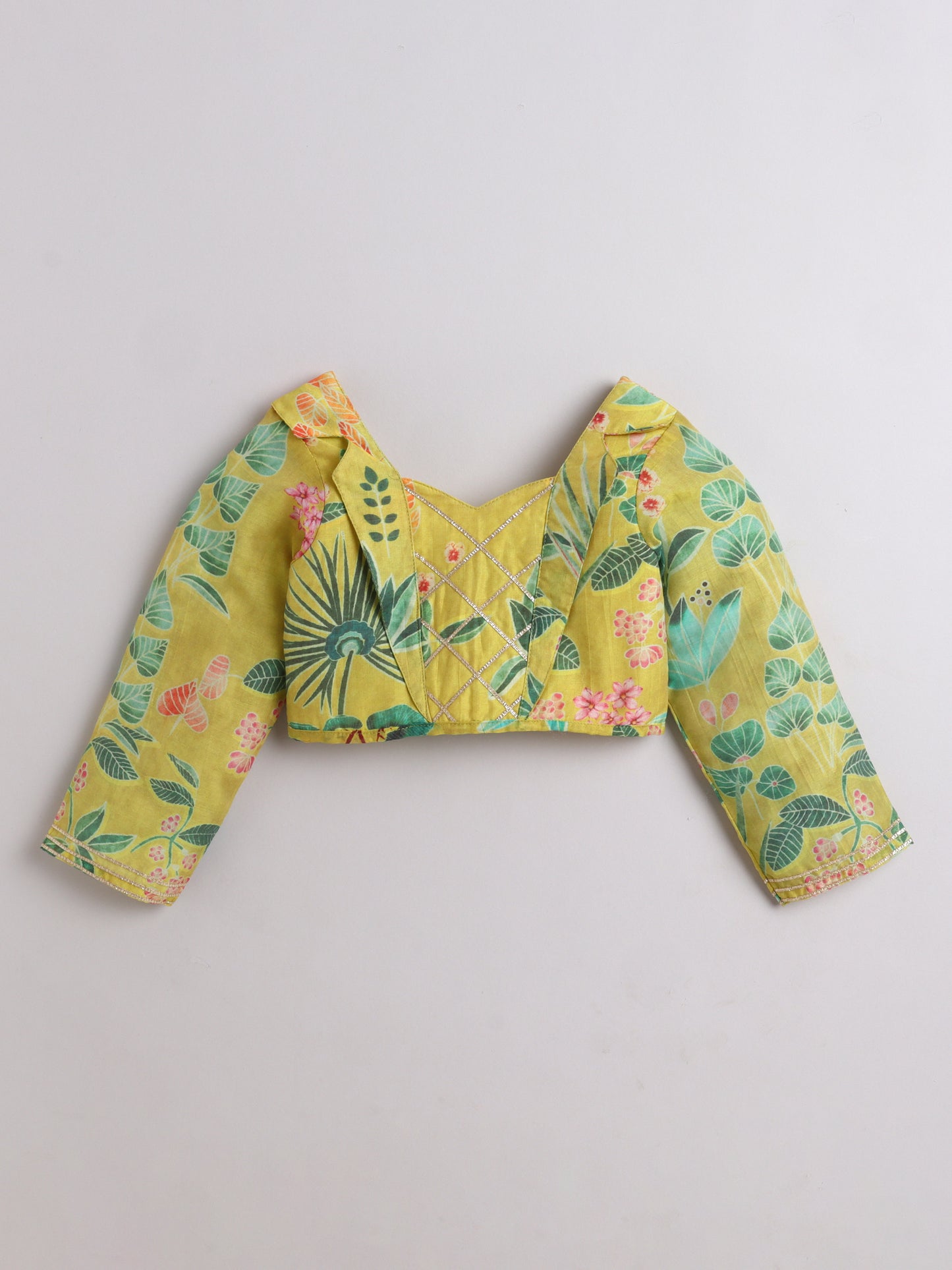 Yellow floral blouse with long sleeves on a light gray background