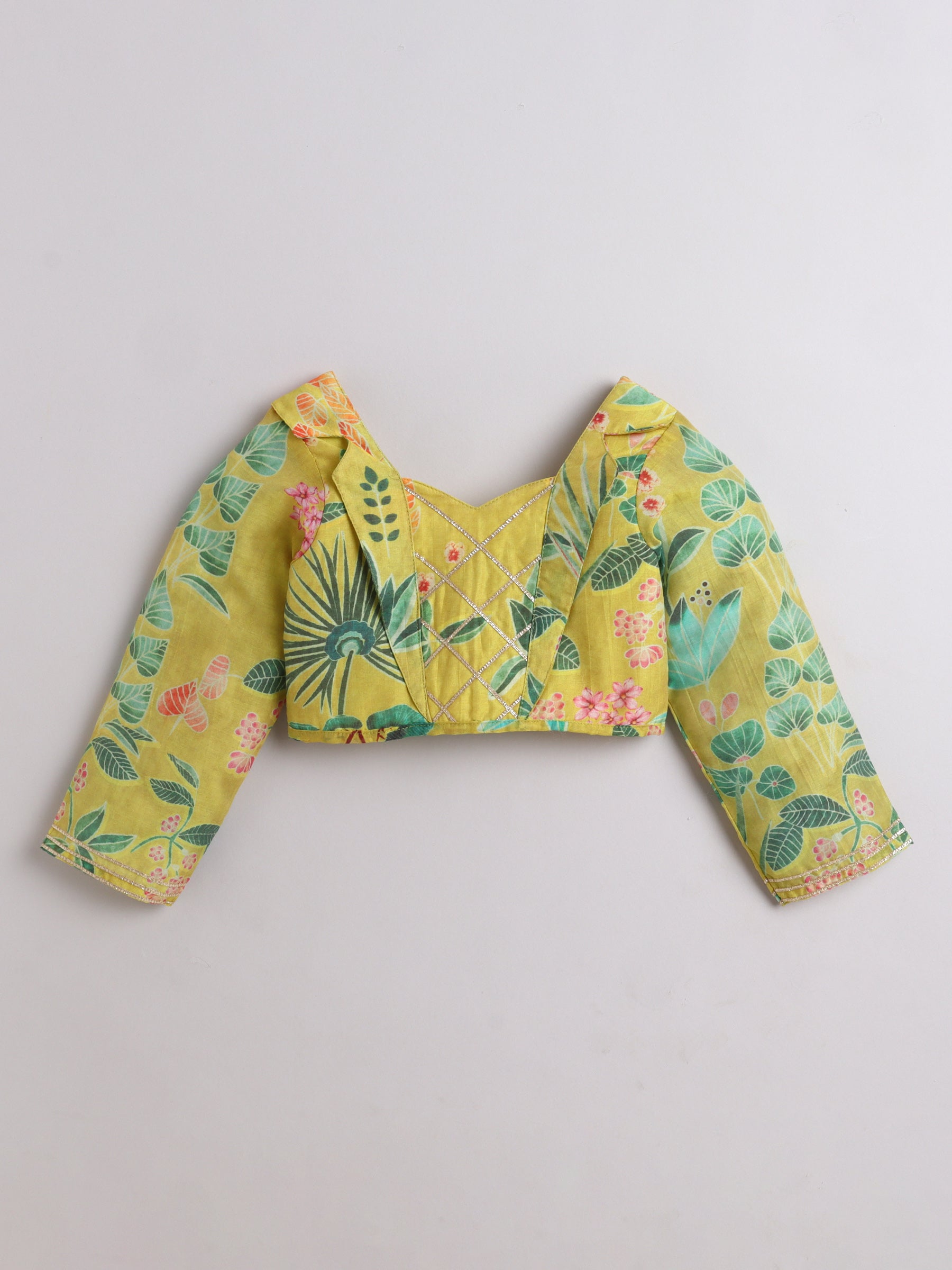 Yellow floral blouse with long sleeves on a light gray background