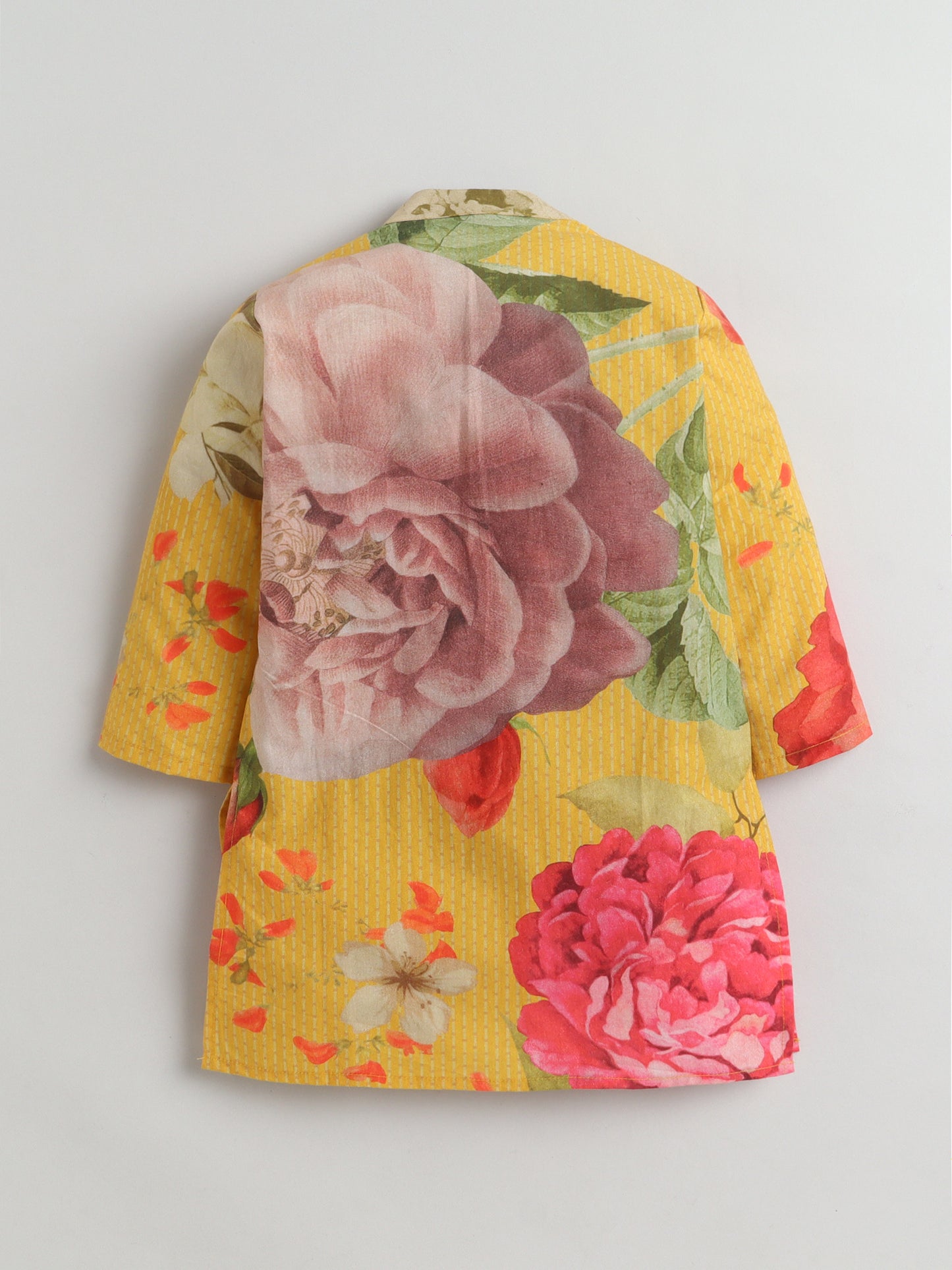 Floral dress with pink and red flowers on a yellow background