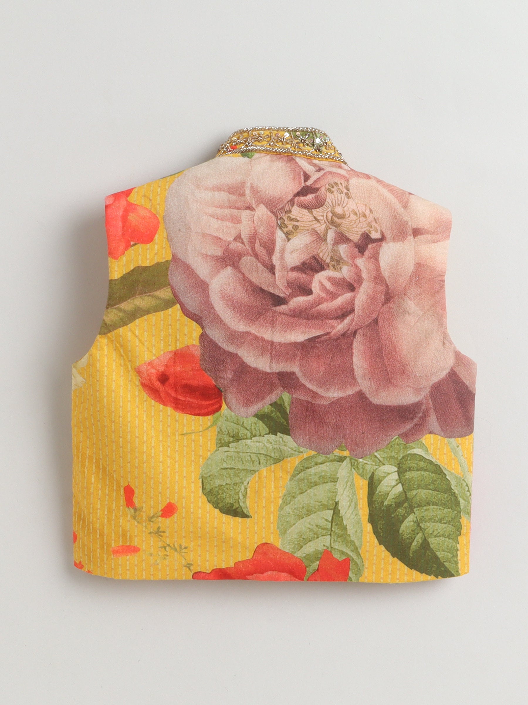 Floral patterned fabric with a prominent pink rose on a yellow background