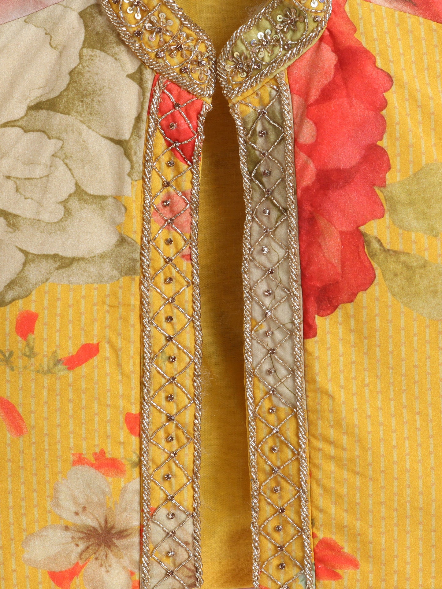 Decorative brooch with intricate patterns on a floral background