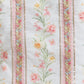 Floral patterned fabric with decorative stripes on a light background