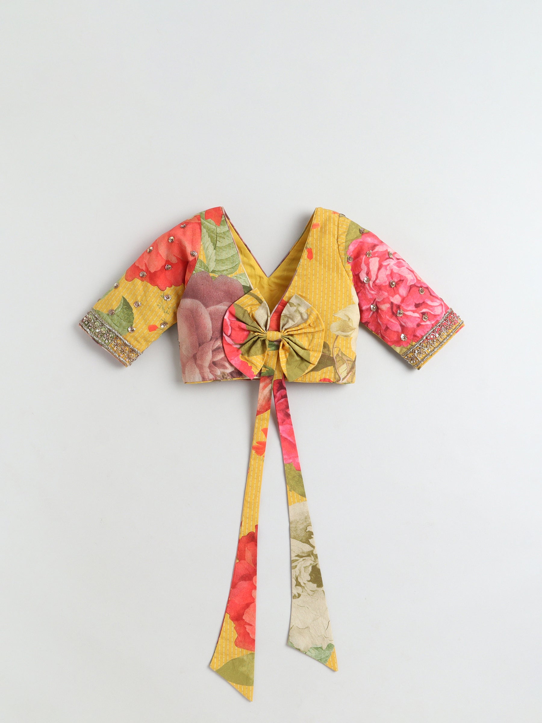 Colorful floral-patterned crop top with a tie detail on a light gray background