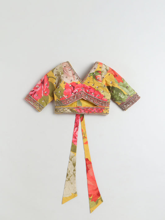 Colorful floral-patterned top with a tie detail on a light gray background