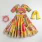 Colorful traditional outfit with floral patterns on a light gray background