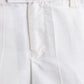 Close-up of white pants with a plain background