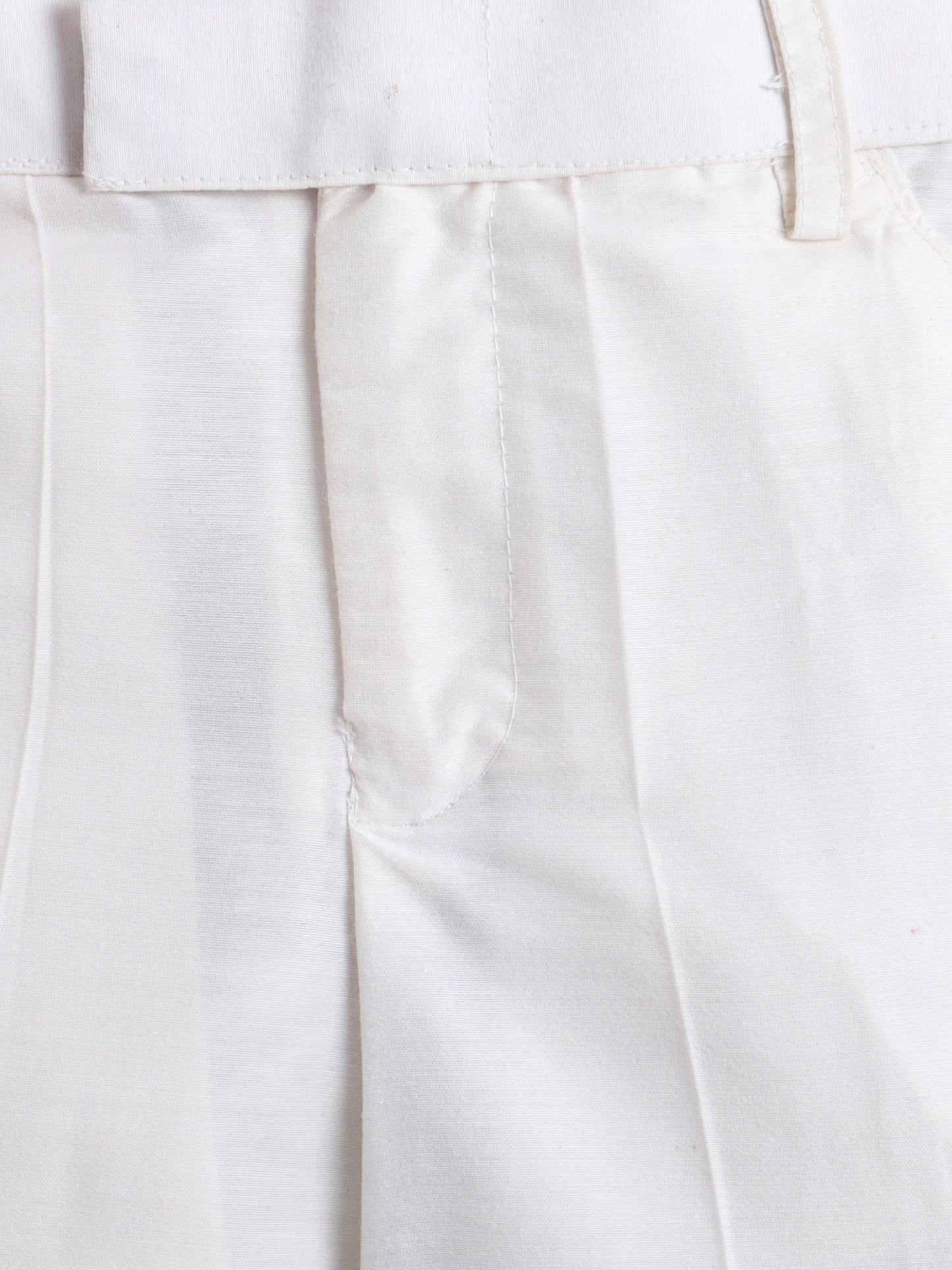 Close-up of white pants with a plain background