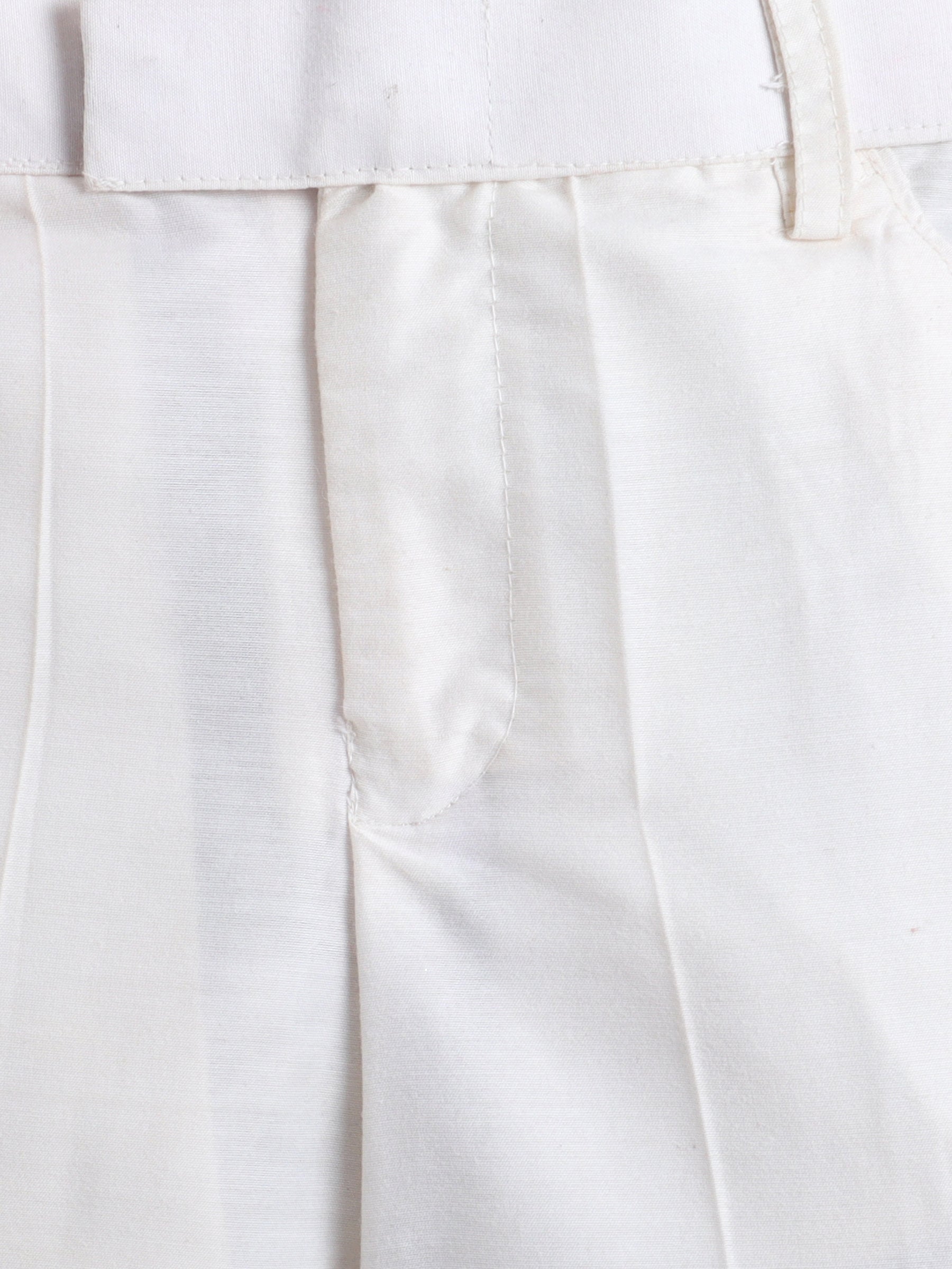 Close-up of white pants with a plain background