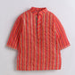 Red and orange striped shirt on a light gray background
