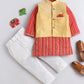 Children's outfit with red and yellow striped shirt, yellow vest, white pants, and brown shoes on a light gray background.