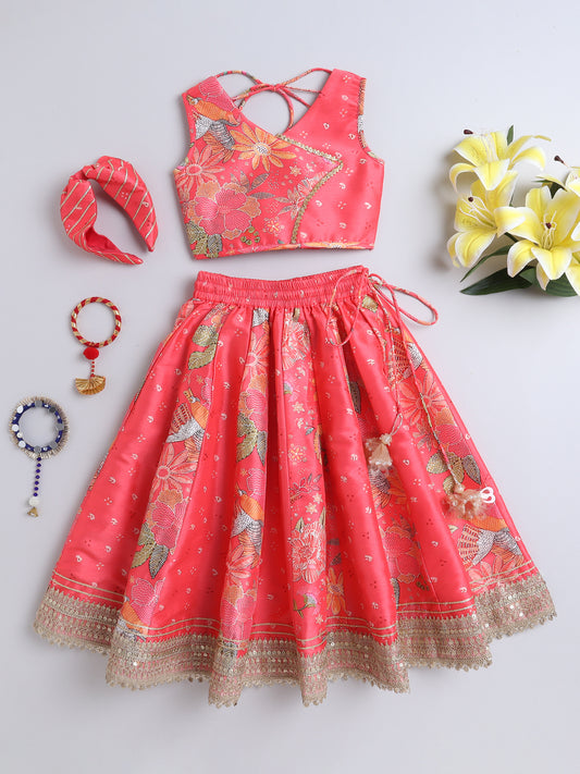 Coral pink traditional outfit with floral patterns on a light gray background