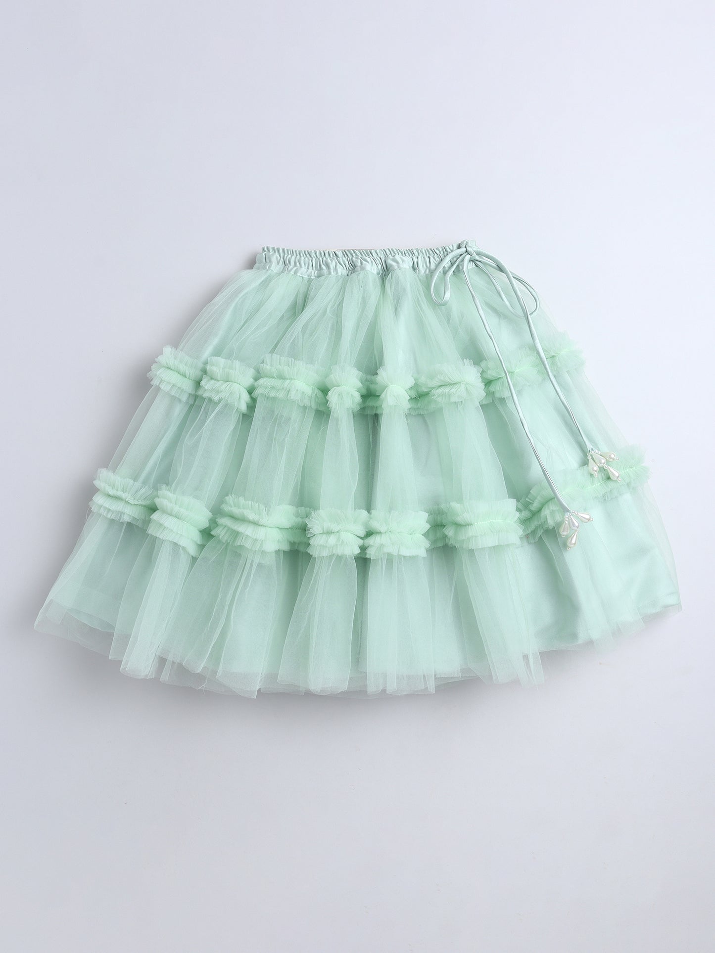 Light green tiered skirt on a white background