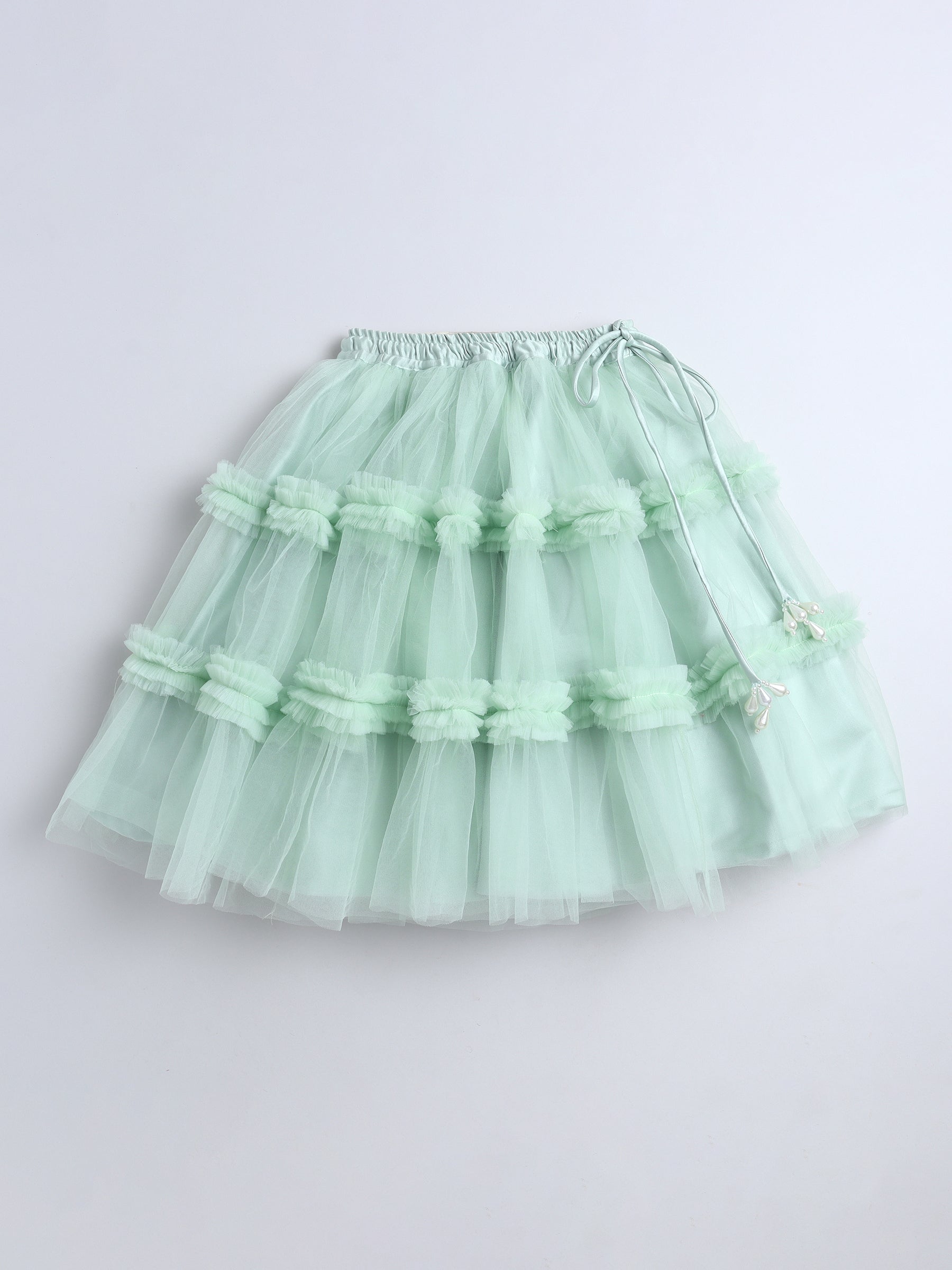 Light green tiered skirt on a white background