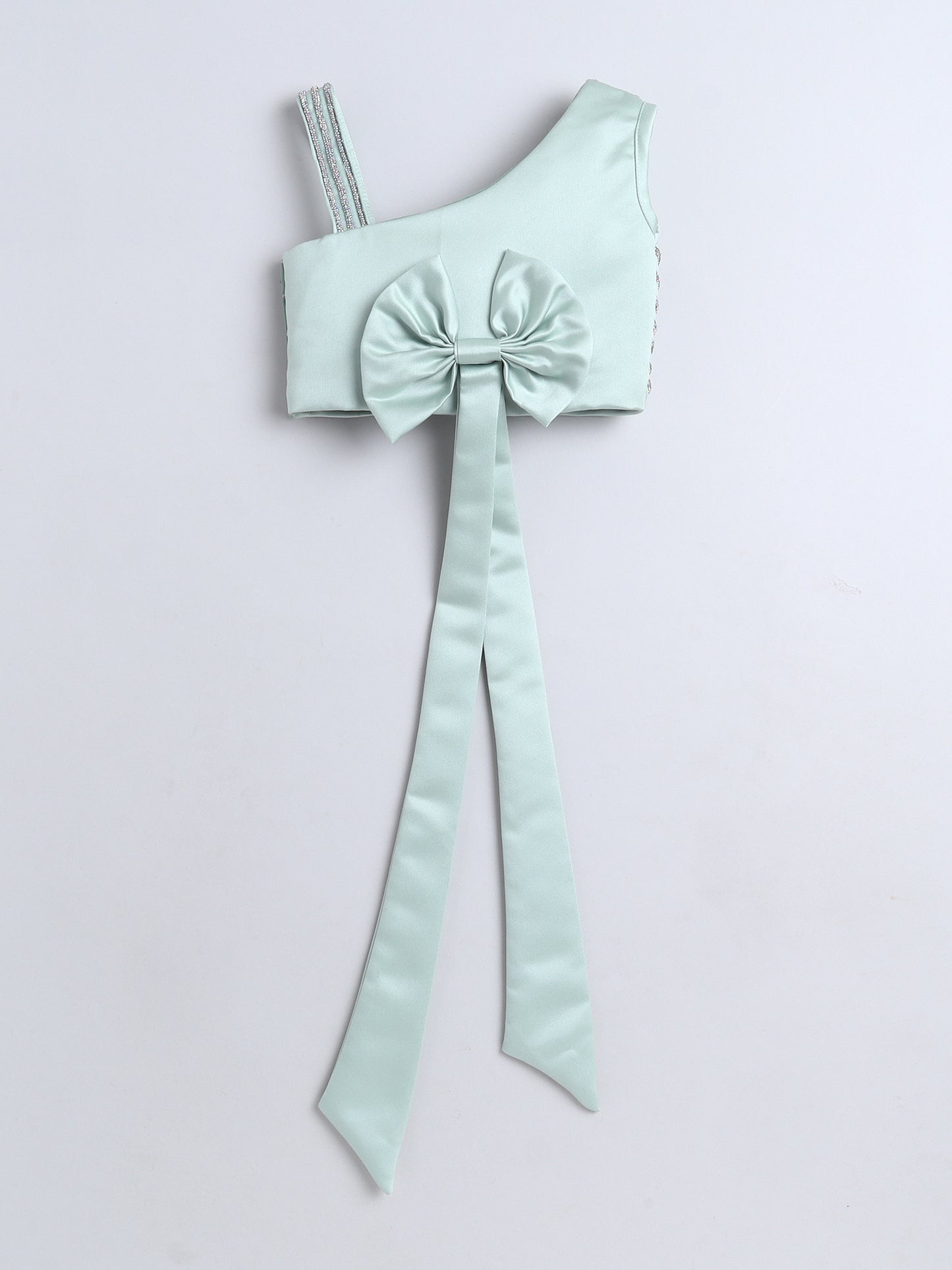Mint green one-shoulder top with a large bow on a light gray background