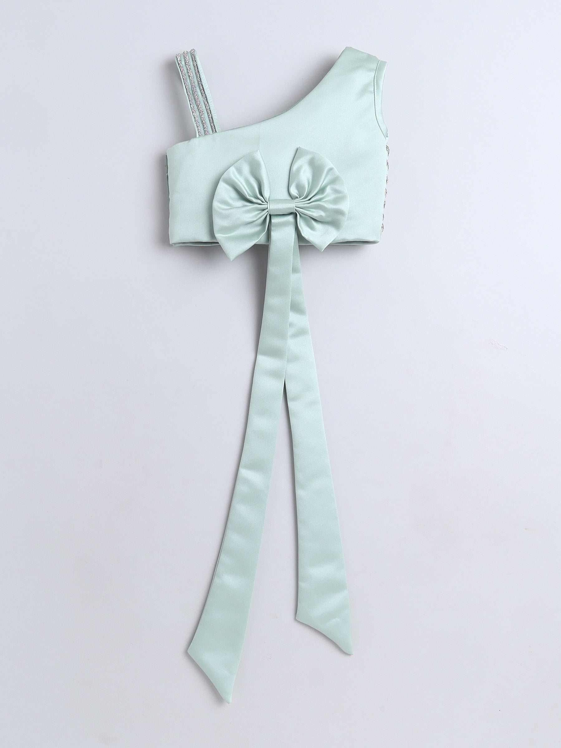 Mint green one-shoulder top with a large bow on a light gray background