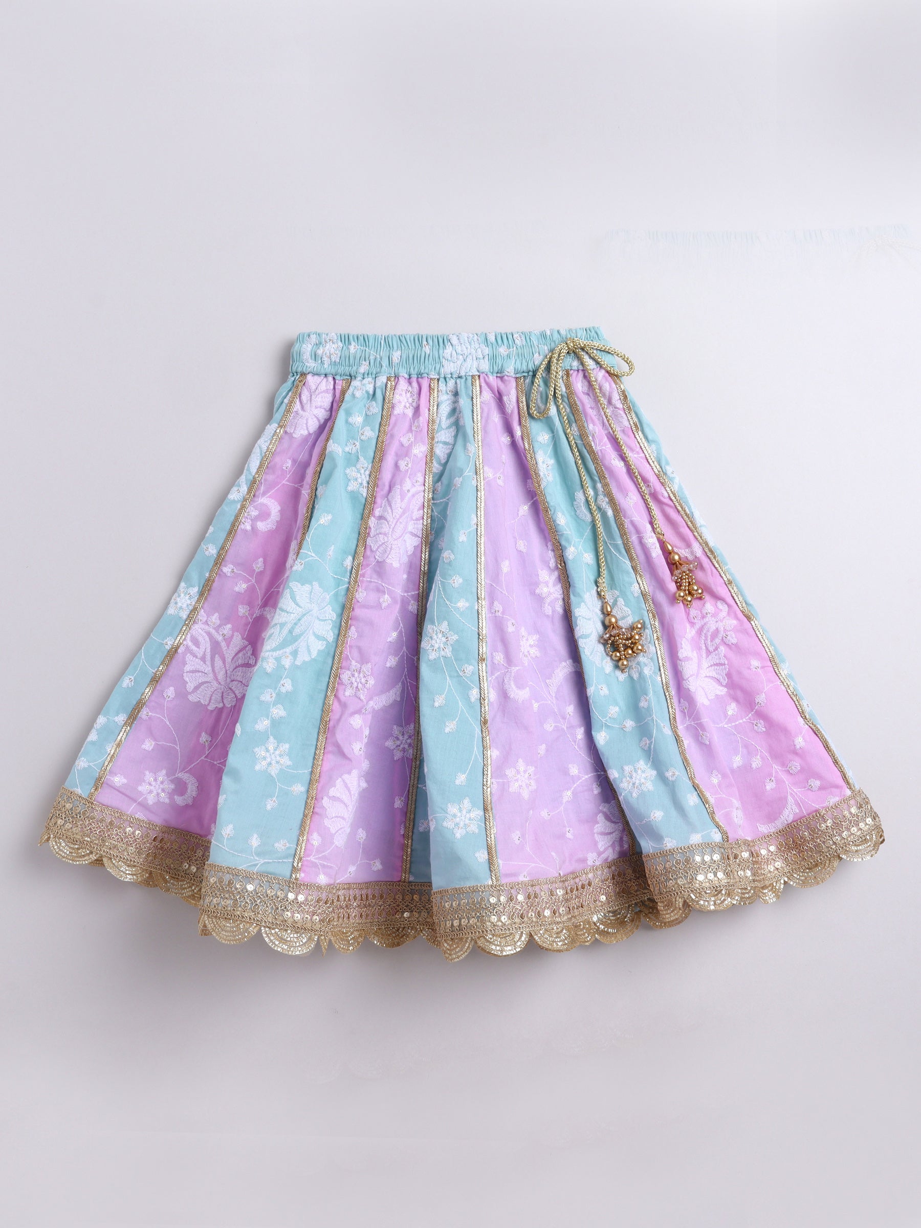 Pastel-colored skirt with floral patterns on a light gray background