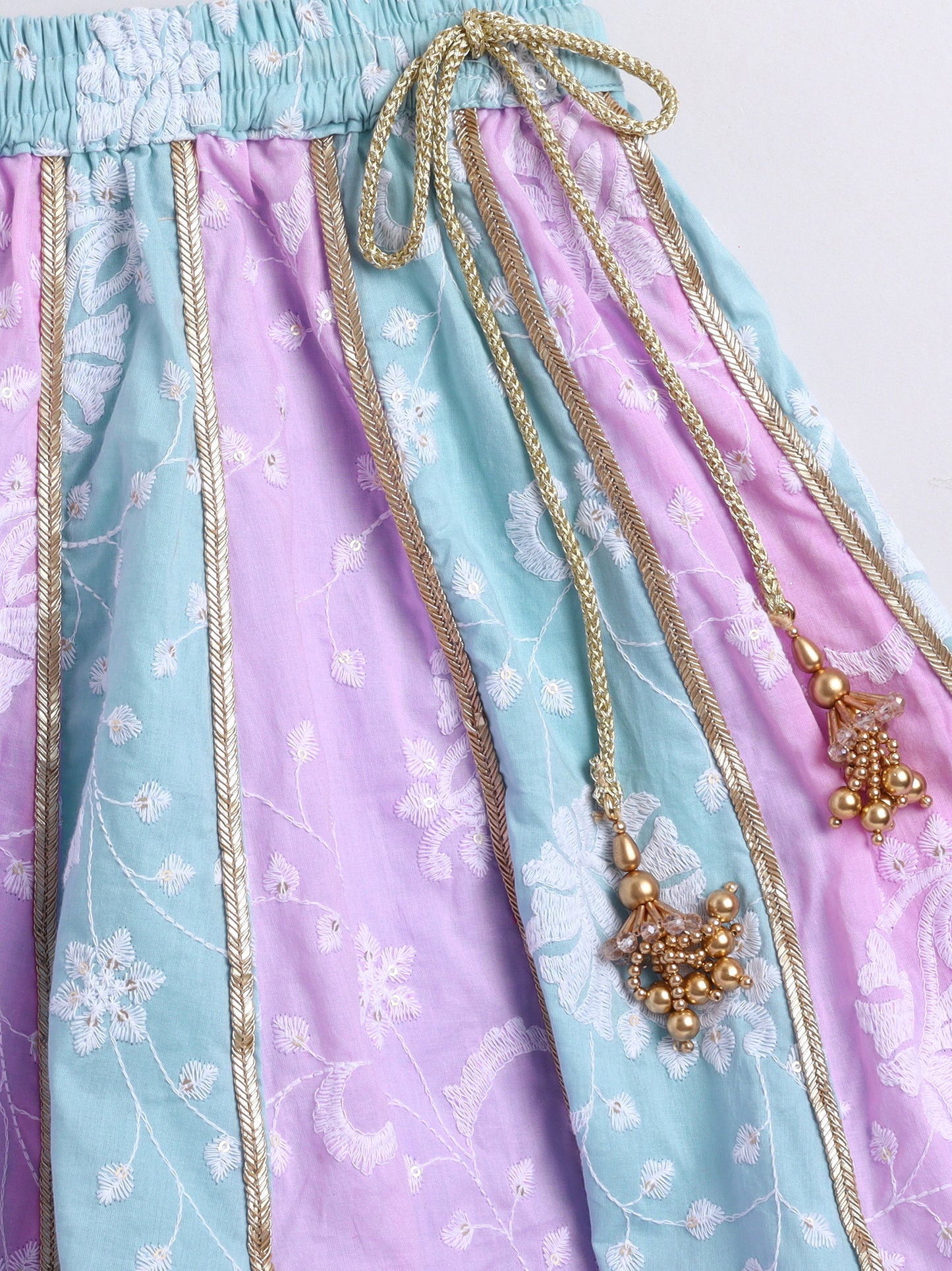 Colorful fabric with floral patterns and decorative elements on a white background