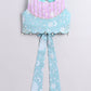 Light blue and pink top with floral patterns on a light gray background