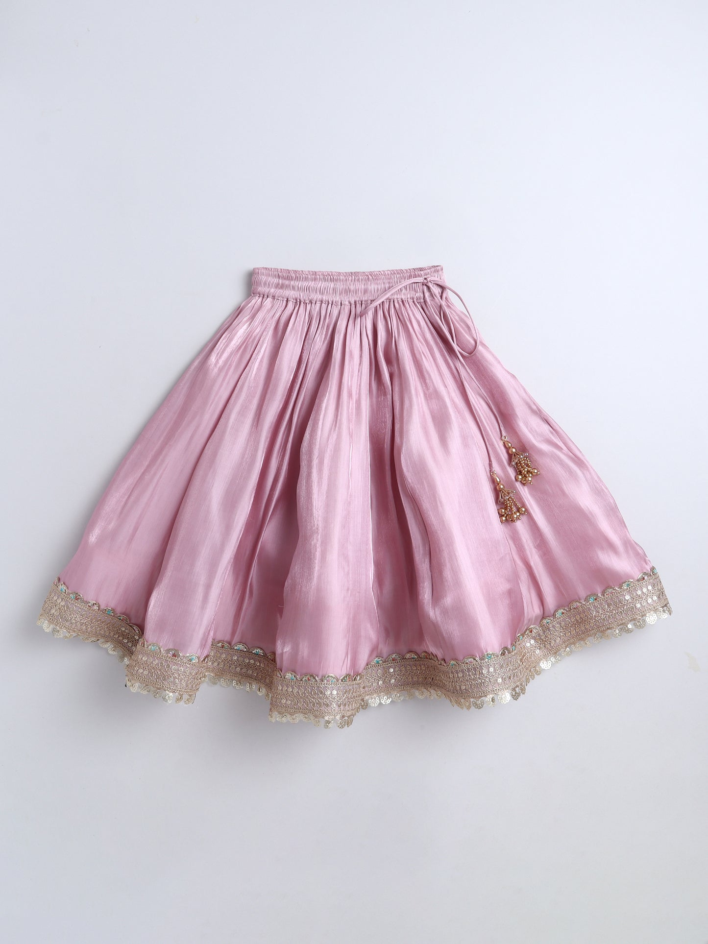 Pink skirt with gold lace trim on a white background