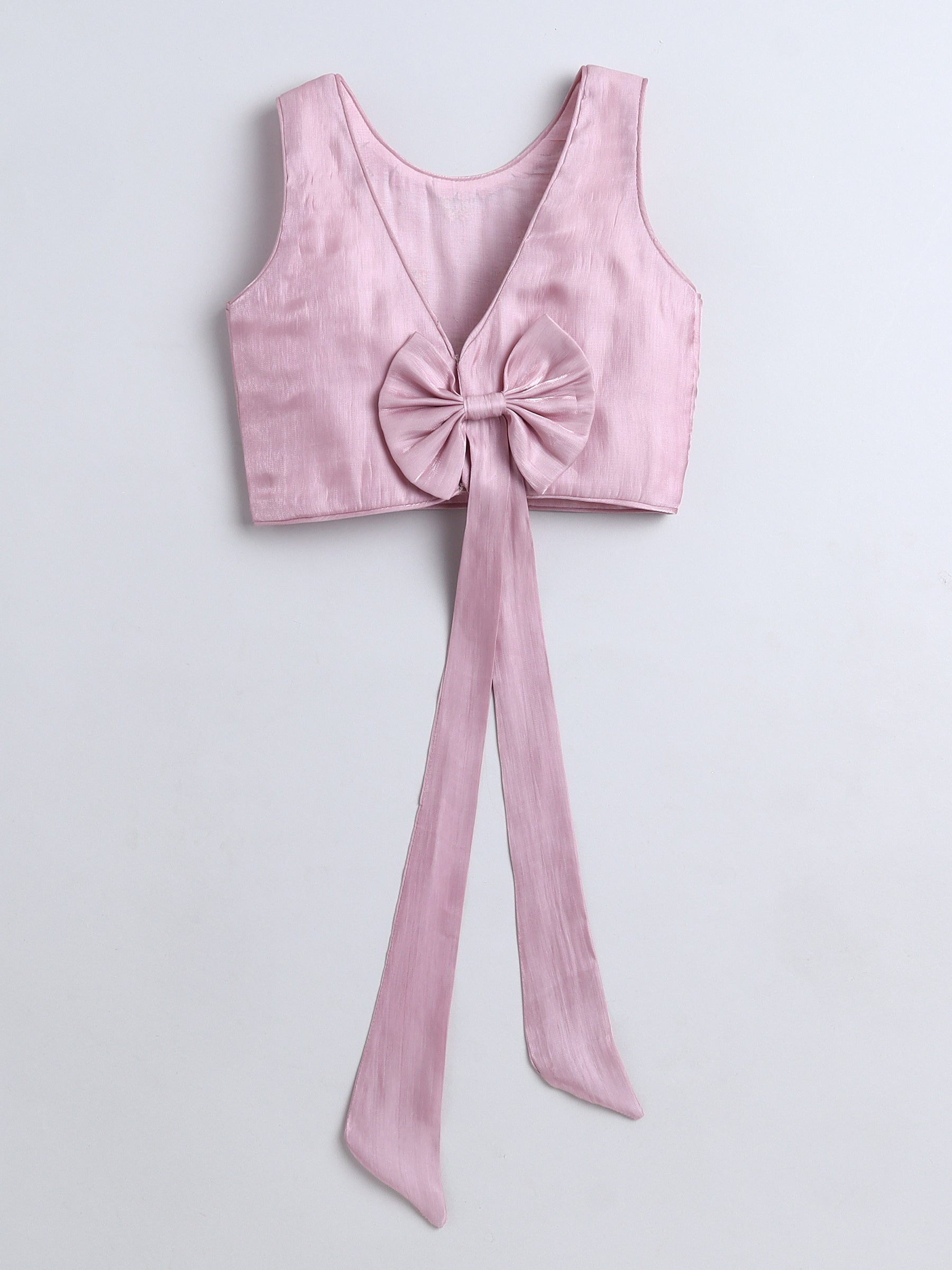 Pink crop top with a large bow on a light gray background