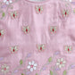 Pink fabric with floral and butterfly embroidery