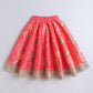Red skirt with floral patterns and gold trim on a light gray background