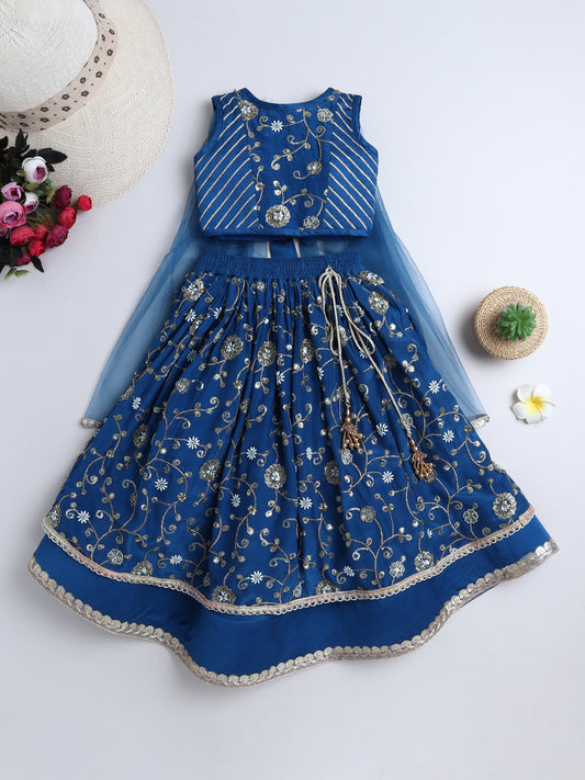 Blue embroidered dress with matching top on a white background