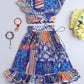 Colorful patterned dress with matching accessories on a blue background