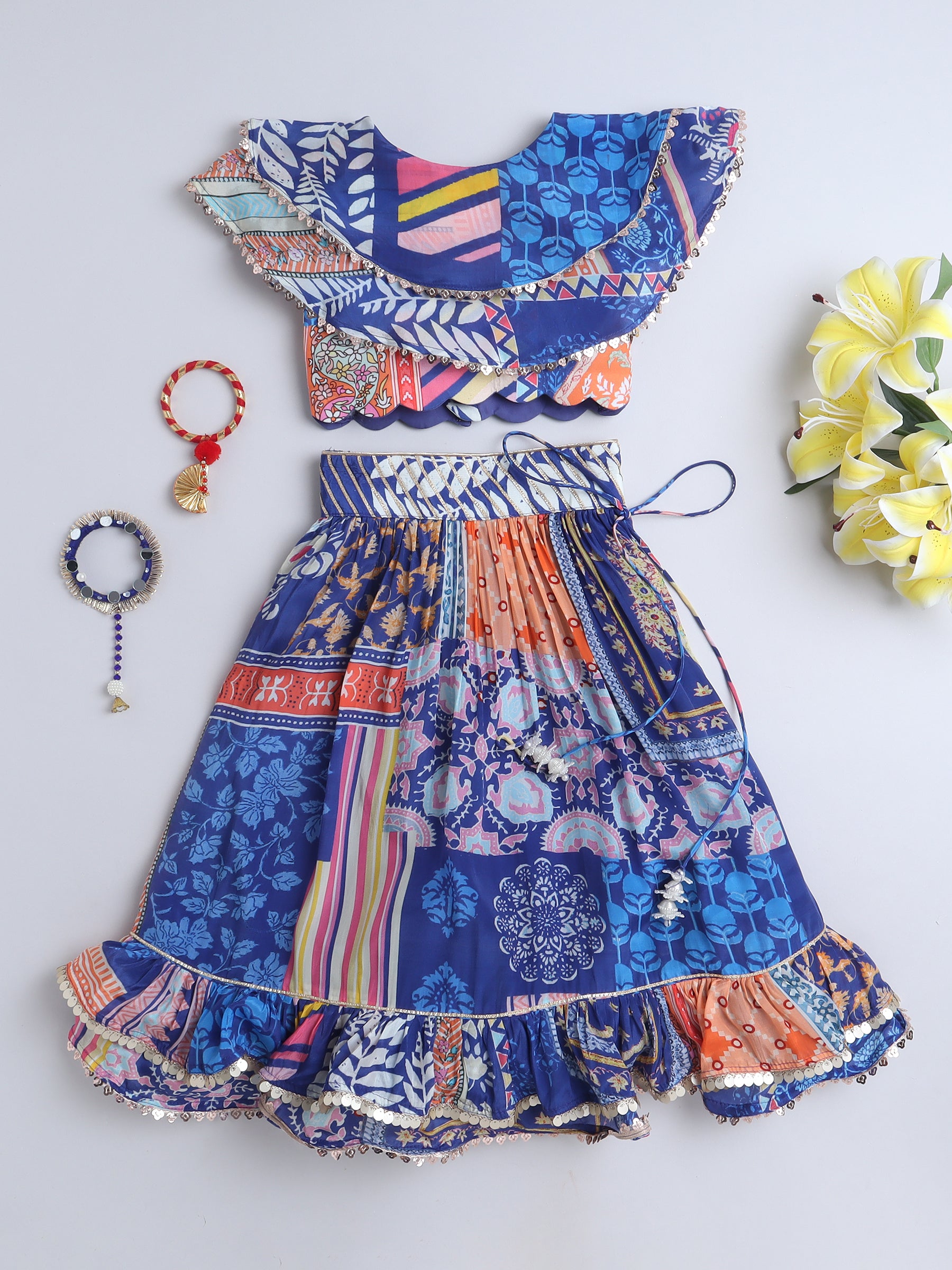 Colorful patterned dress with matching accessories on a blue background