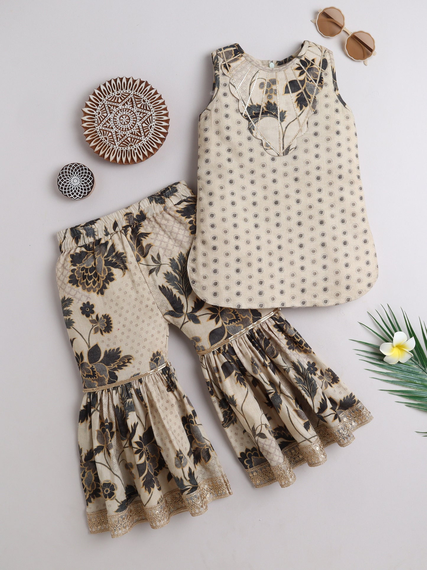 Elegant kids ethnic wear featuring a floral top and flared pants in neutral tones