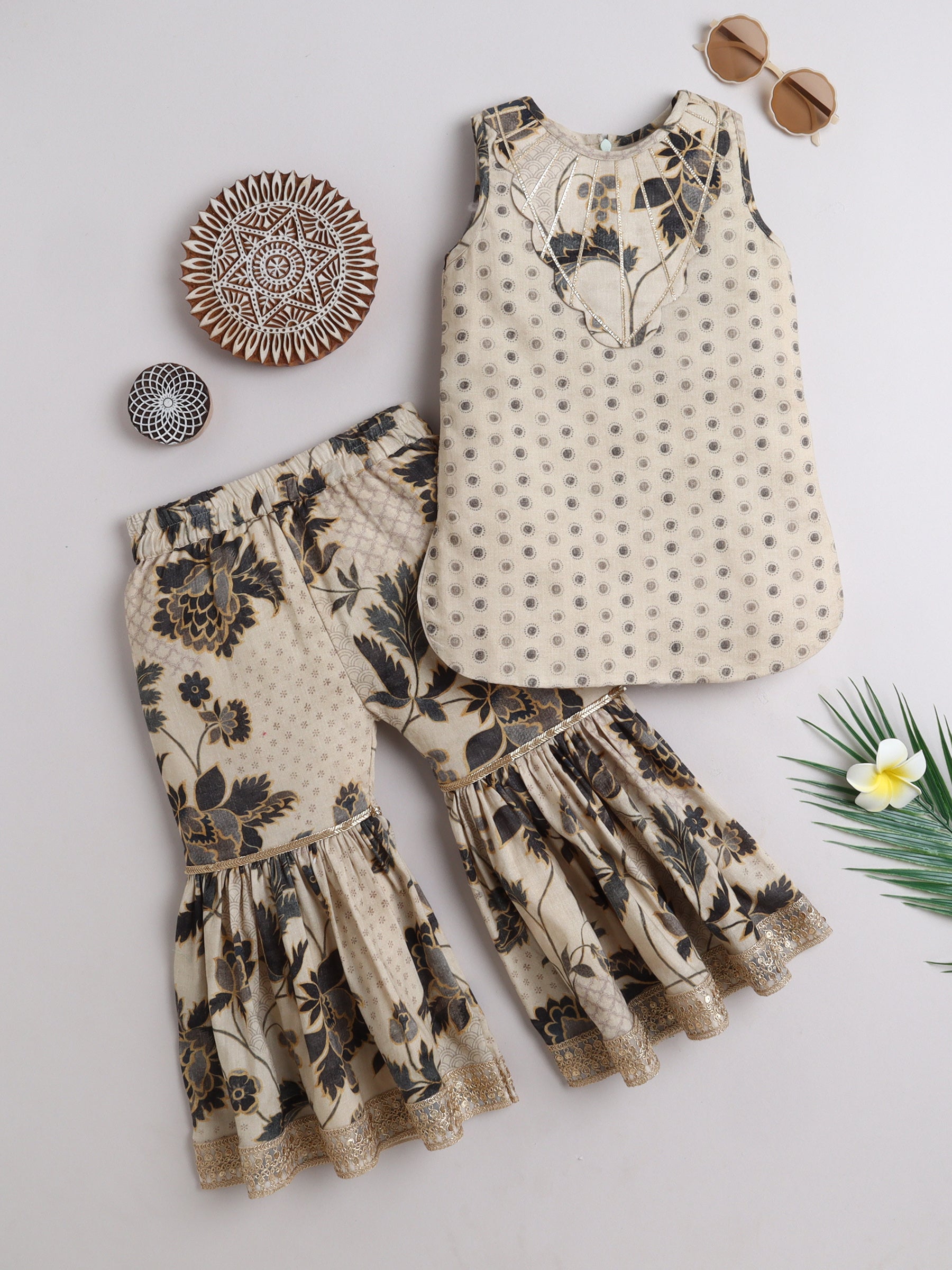 Elegant kids ethnic wear featuring a floral top and flared pants in neutral tones
