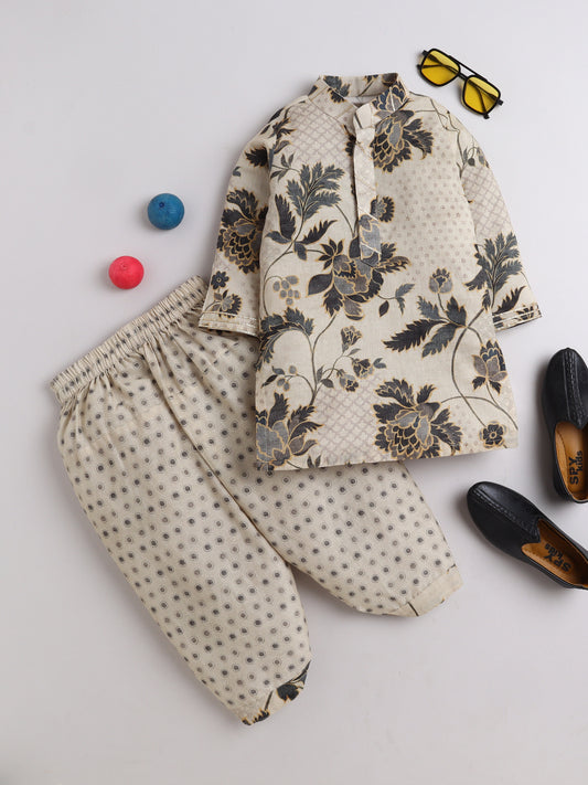 Beige cotton floral printed kurta and polka dot dhoti set for boys, displayed with accessories including black loafers, sunglasses, and colorful balls – traditional kidswear outfit from Fun Little Ones