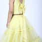Side view highlighting yellow lehenga’s blouse with a bow. elastic waist with ornate ruffle's.